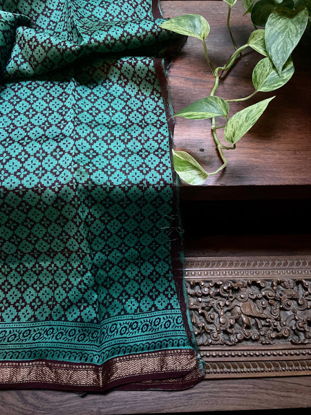 Crafted with a green and dark maroon combination, this elegant Green Bagh printed Maheshwari Saree is a timeless classic. The hand prints offer a unique touch while the Maheshwari silk cotton provides a luxurious look and feel for comfort. Bring timeless style to your wardrobe with this special piece.  Fabric- Silk Cotton