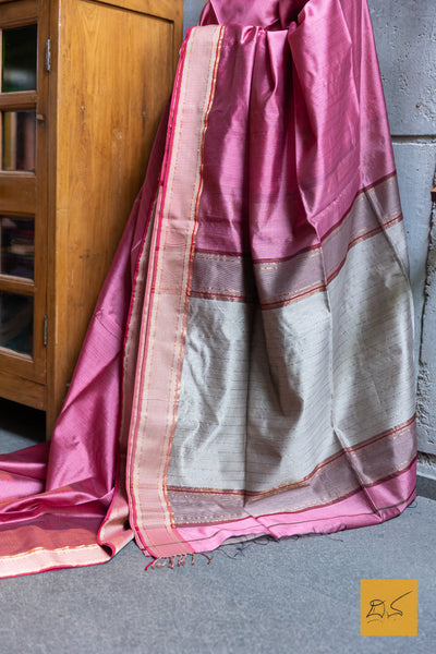 Discover the exquisite craftsmanship of the PINK-RED MAHESHWARI SILK COTTON HANDWOVEN SAREE. Made with the finest silk and cotton blend, this saree boasts a luxurious feel and stunning drape. Perfect for any occasion, this saree is a timeless addition to any wardrobe.