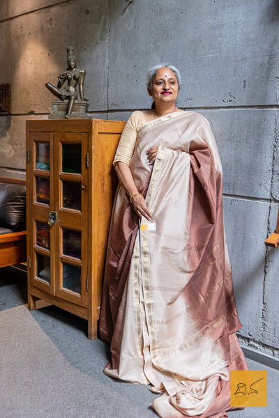 Expertly handwoven, this Beige-Dark Brown Ombre Maheshwari Silk Cotton Saree is a stunning addition to your wardrobe. Made from luxurious silk cotton, it features a unique ombre design that seamlessly fades from beige to dark brown.