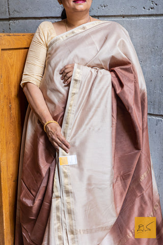 Expertly handwoven, this Beige-Dark Brown Ombre Maheshwari Silk Cotton Saree is a stunning addition to your wardrobe. Made from luxurious silk cotton, it features a unique ombre design that seamlessly fades from beige to dark brown.