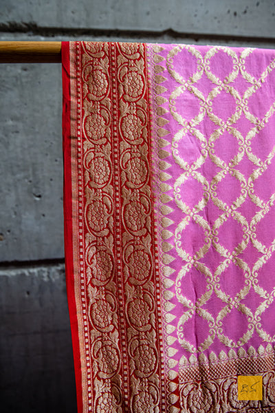 All set to be your loved one! Presenting this georgette banarasi saree in contrast shades of pink and red. A saree with zari jaal pattern suitable for weddings and festivals. What are you waiting for?