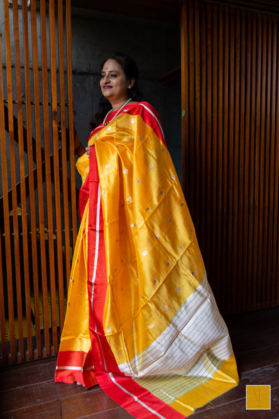 Bumblebee yellow handwoven chanderi silk saree with meenakari buttas and red mashru border.  This yellow tone Chanderi silk sare will add glamour to your wardrobe. Saree gets a completed look with the eknaliya buttas with red meenakari and red mashru border. The saree is extremely soft and very easy to drape. 
