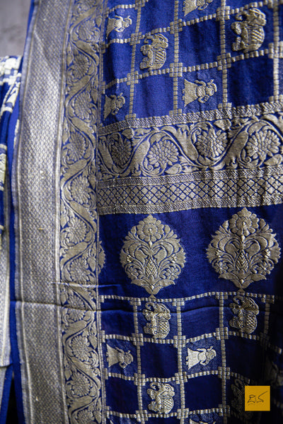 You are LIMITLESS! Presenting this dark blue banarasi georgette saree with zari jaal work. A perfect saree for  a wedding reception. Minimal accessories and Gajra should complete the look.