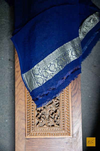 You are LIMITLESS! Presenting this dark blue banarasi georgette saree with zari jaal work. A perfect saree for  a wedding reception. Minimal accessories and Gajra should complete the look.