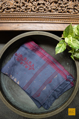 A super soft handspun cotton saree with handwoven jamdani weave. This saree is perfect to be comfortably draped the whole day.  Fabric- Cotton Colour-Bluish grey Length- 6.5 mSudha Hand spun Cotton Handwoven Jamdani Saree