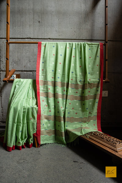 Sushma Hand spun Cotton Handwoven Jamdani Saree. A super soft hand spun cotton saree with handwoven jamdani weave. A saree perfect to be draped the whole day very comfortably.  Fabric- Hand spun cotton  Colour- Green  Length- 6.5m