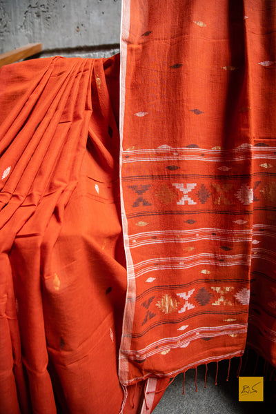 Sudeshna Hand spun Cotton Handwoven Jamdani Cotton Saree. A super soft handspun cotton saree with handwoven jamdani weave. This saree is perfect to drape the whole day very comfortably.  Fabric- Hand spun Cotton Colour- Orange Length- 6.5m