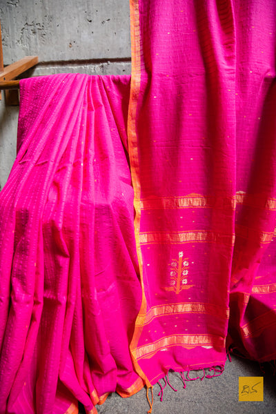 Suguna Hand spun Cotton Handwoven Jamdani Saree. A super soft handspun cotton saree with handwoven jamdani weave. This saree is perfect to drape the whole day very comfortably.  Fabric- Hand spun Cotton Colour- Pink-Orange Length- 6.5m