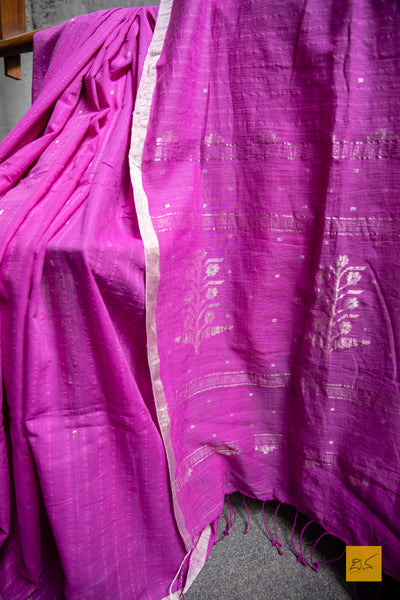 Sulochana Hand spun Cotton Handwoven Jamdani Saree. A super soft hand spun cotton saree with handwoven jamdani weave. This saree is perfect to drape the whole day very comfortably.   Fabric- Cotton Colour- Magenta  Length- 6.5m