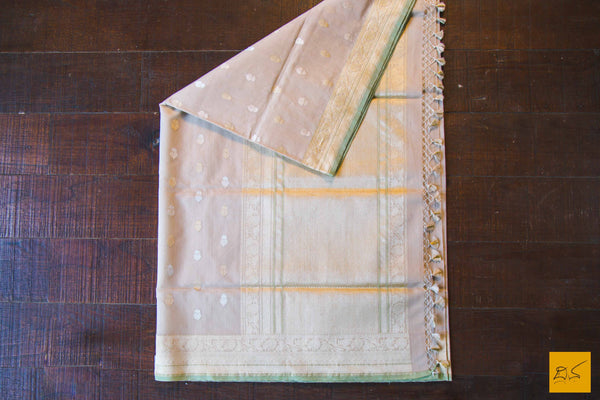 A lovely Banarasi cotton saree with white body and green slevedge. The body has golden silver buttas woven in it. The blouse is of golden brocade intricately woven. New trend of Banarasi Saree designs, Banarasi Saree for artists, art lovers, architects, saree lovers, Saree connoisseurs, musicians, dancers, doctors, Banarasi Katan silk saree, indian saree images, latest sarees with price, only saree images, new Banarasi saree design.