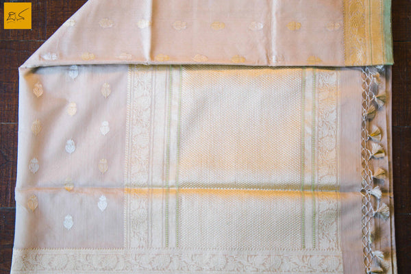 A lovely Banarasi cotton saree with white body and green slevedge. The body has golden silver buttas woven in it. The blouse is of golden brocade intricately woven. New trend of Banarasi Saree designs, Banarasi Saree for artists, art lovers, architects, saree lovers, Saree connoisseurs, musicians, dancers, doctors, Banarasi Katan silk saree, indian saree images, latest sarees with price, only saree images, new Banarasi saree design.