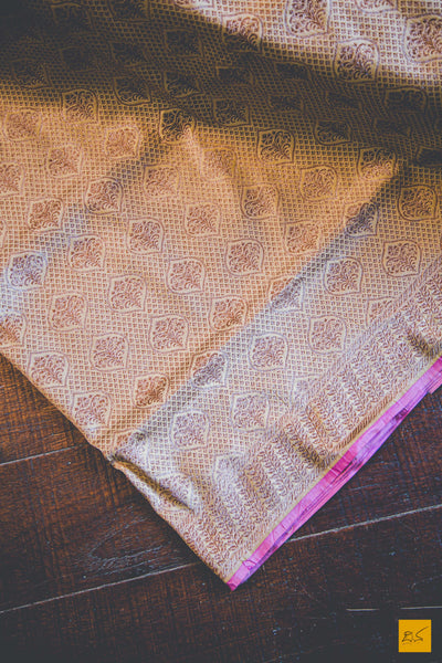 A beautiful banarasi katan silk handwoven sari with all over jaal with buttas. TheBeige Brown body gives a soothing definition to the saree. New trend of Banarasi Saree designs, Banarasi Saree for artists, art lovers, architects, saree lovers, Saree connoisseurs, musicians, dancers, doctors, Banarasi katan silk saree, indian saree images, latest sarees with price, only saree images, new Banarasi saree design.