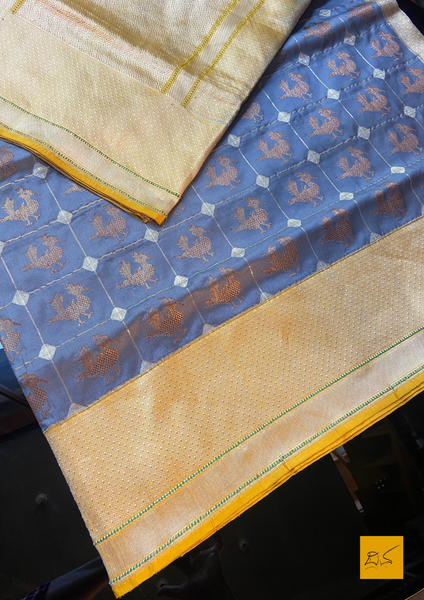 "I love really simple colours - lots of cream, beige, and grey. "  Does it sound familiar? Then this is your pick.  Presenting this banarasi katan silk handwoven saree in a unique combination of Grey and Yellow. This saree has a skirt border and the motifs are woven in kadhwa style. This saree is gorgeous as it is a kadhiyal too. Meaning the body colour and the border colours are different and it makes the saree to stand out and make it special. Needless to say, very soft and easy to drape. 