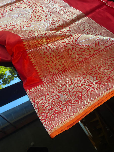 Simplicity, Grandeur and Elegance- This saree has all..  Presenting this gorgeous plain red banarasi katan silk saree with orange selvedge. This saree has a woven golden zari border and pallu with silver meenakari.    Fabric- Katan Silk Colour- Scarlet red
