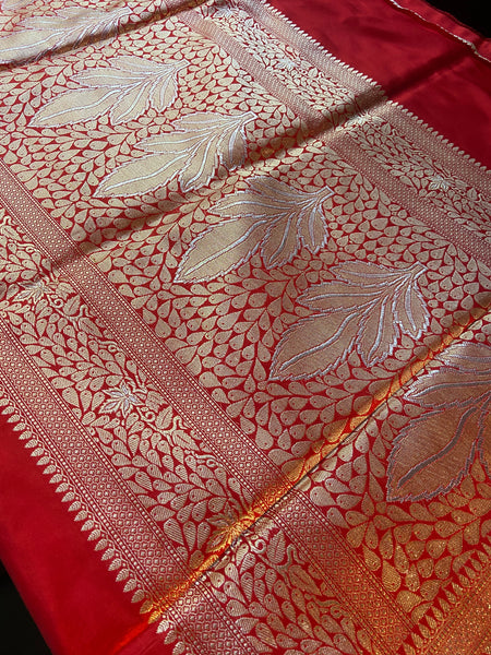 Simplicity, Grandeur and Elegance- This saree has all..  Presenting this gorgeous plain red banarasi katan silk saree with orange selvedge. This saree has a woven golden zari border and pallu with silver meenakari.    Fabric- Katan Silk Colour- Scarlet red