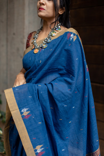 A super soft handspun cotton saree with handwoven jamdani weave. This saree is perfect to be comfortably worn for the whole day.   Fabric- Cotton Colour- Blue Length- 6.5m